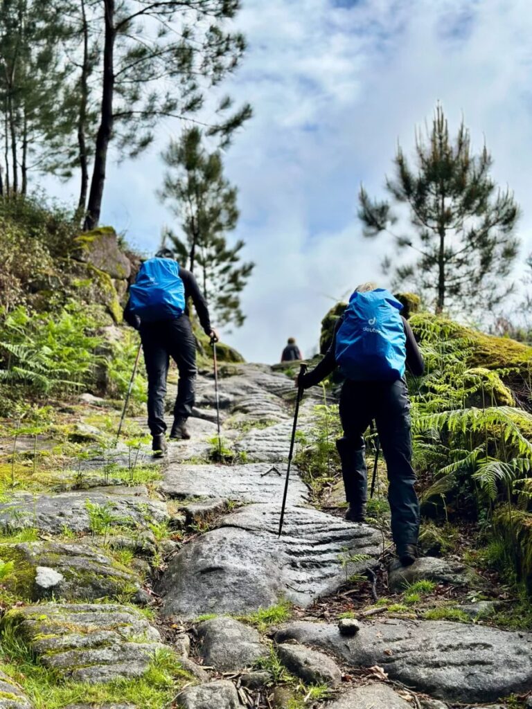Hikers on a rocky granite trail in Gerês