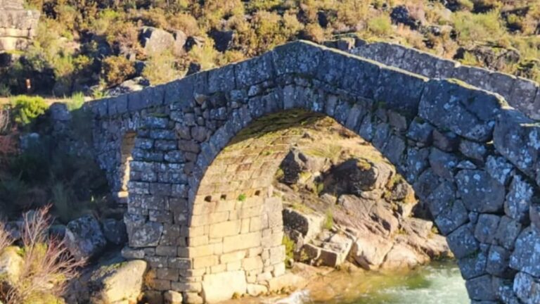 Medieval stone bridge over a mountain river