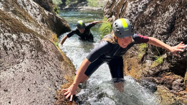 Wading through a crystal-clear mountain river in Gerês